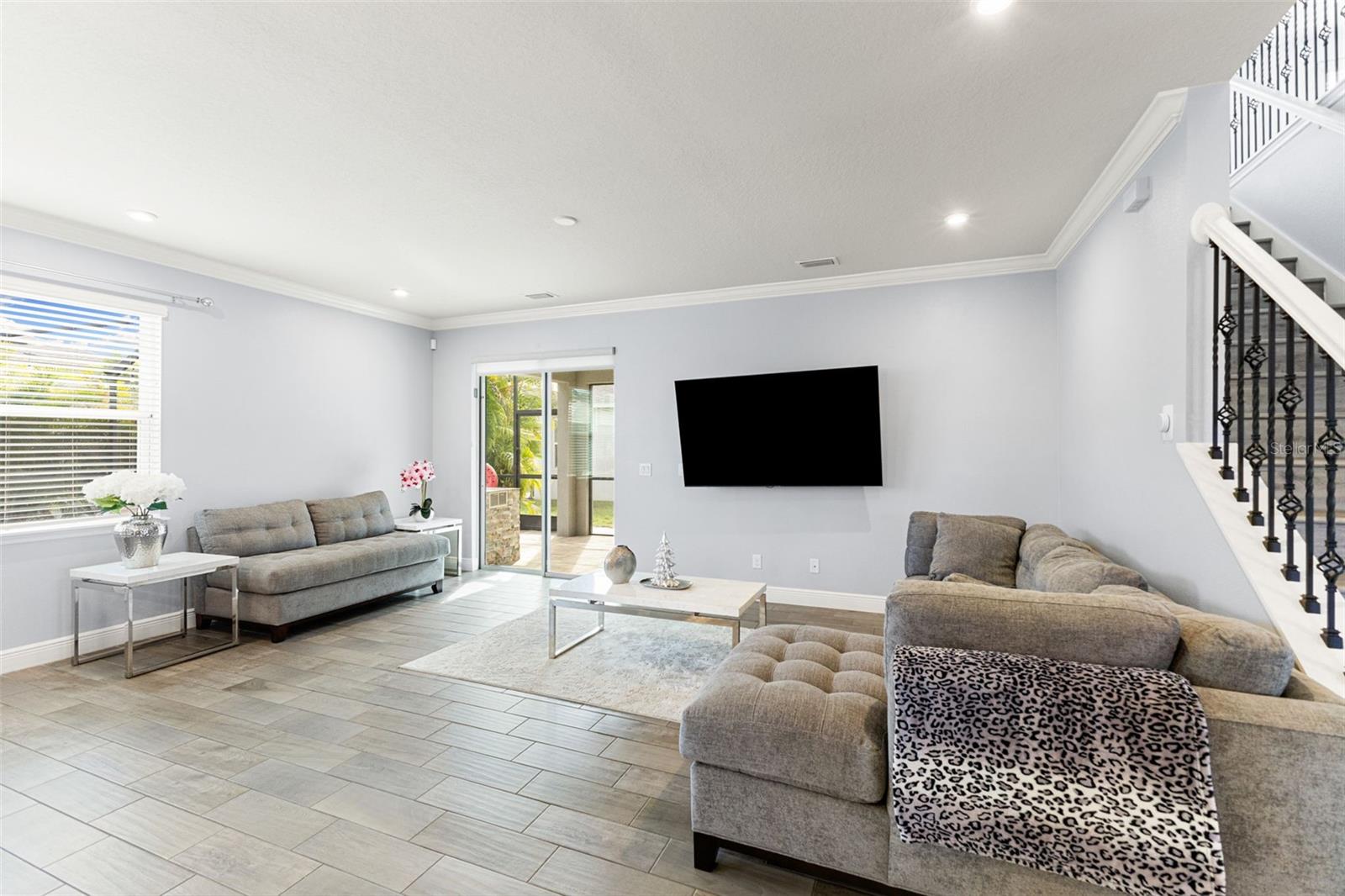 Family room with wrought iron staircase