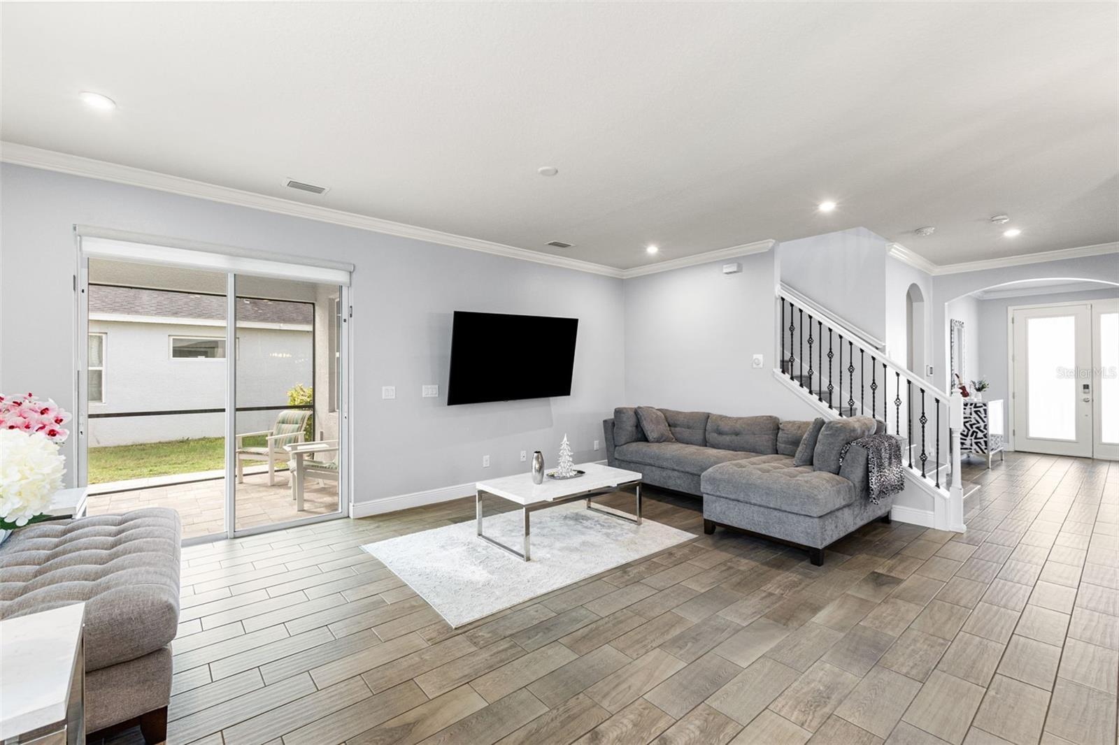 Family room with wrought iron staircase