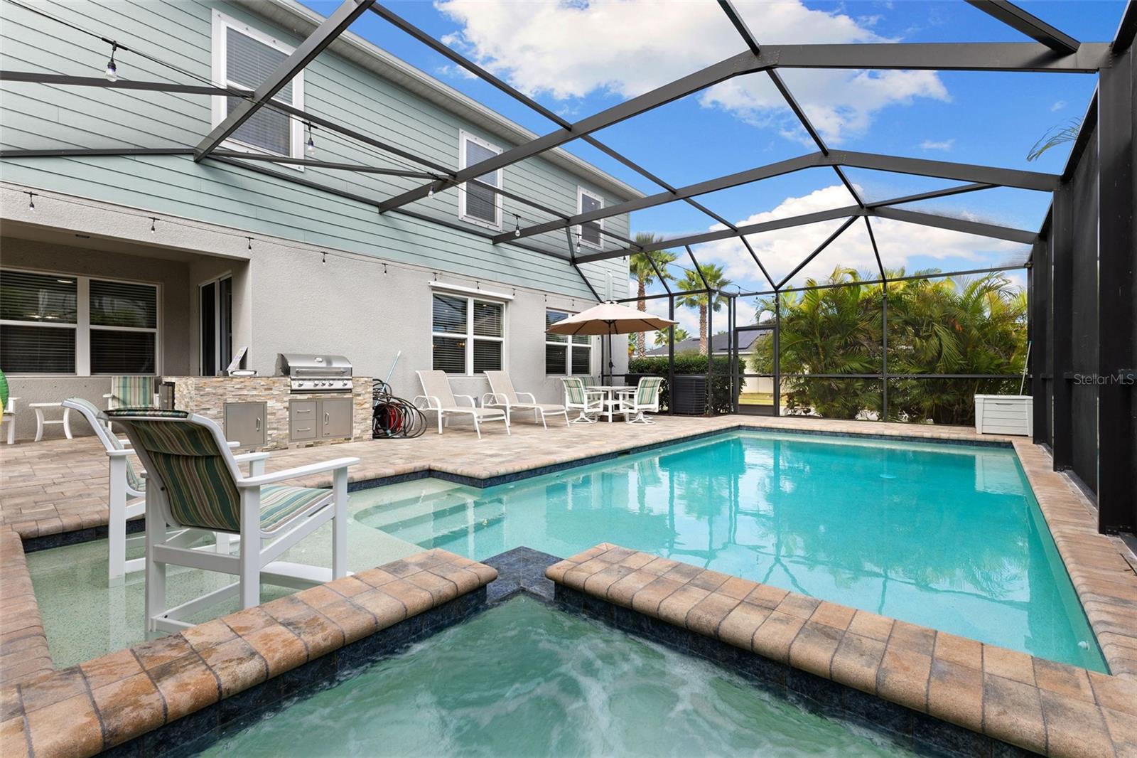 Screened lania with saltwater pool and spa and plenty of room for entertainment
