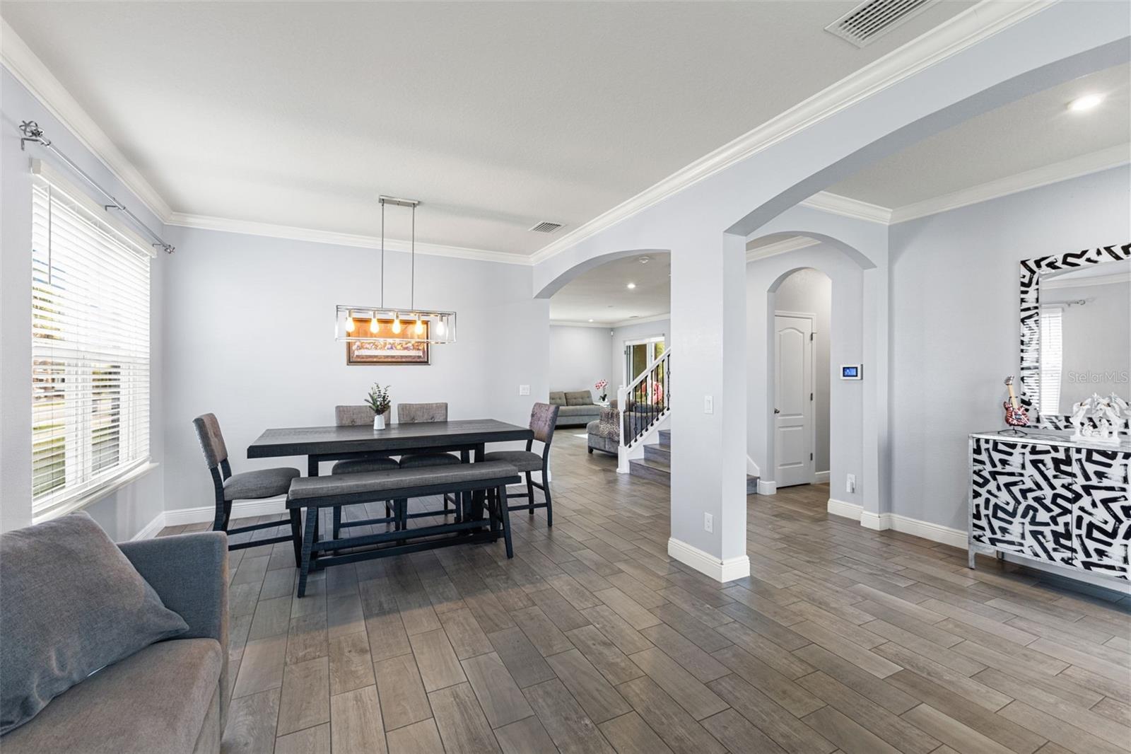 Formal dining room with  beautiful overhead lighting