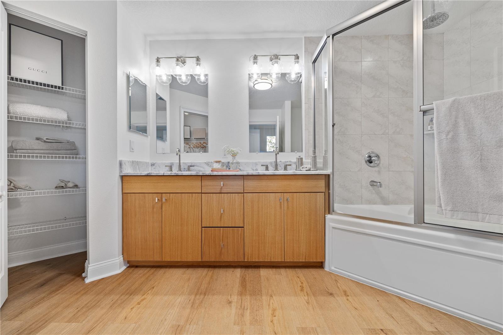 ensuite bathroom with walk-in closet and linen closet