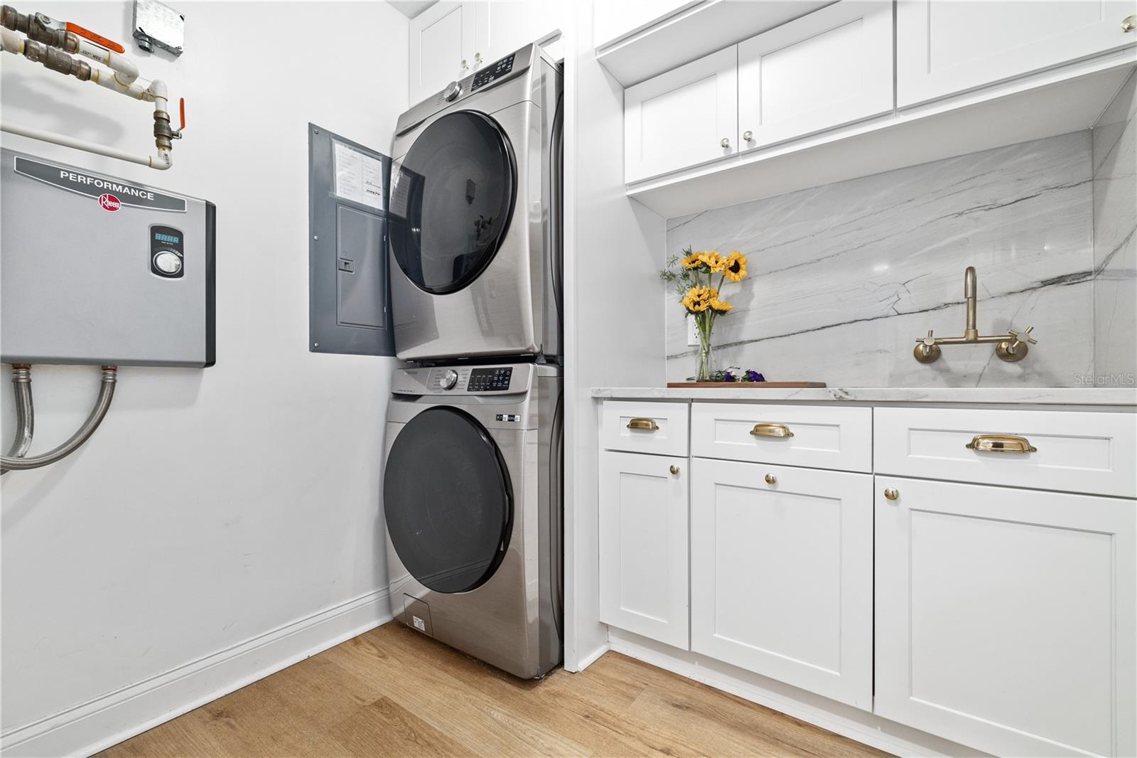 in-unit laundry room, made more spacious by upgraded tankless water heater