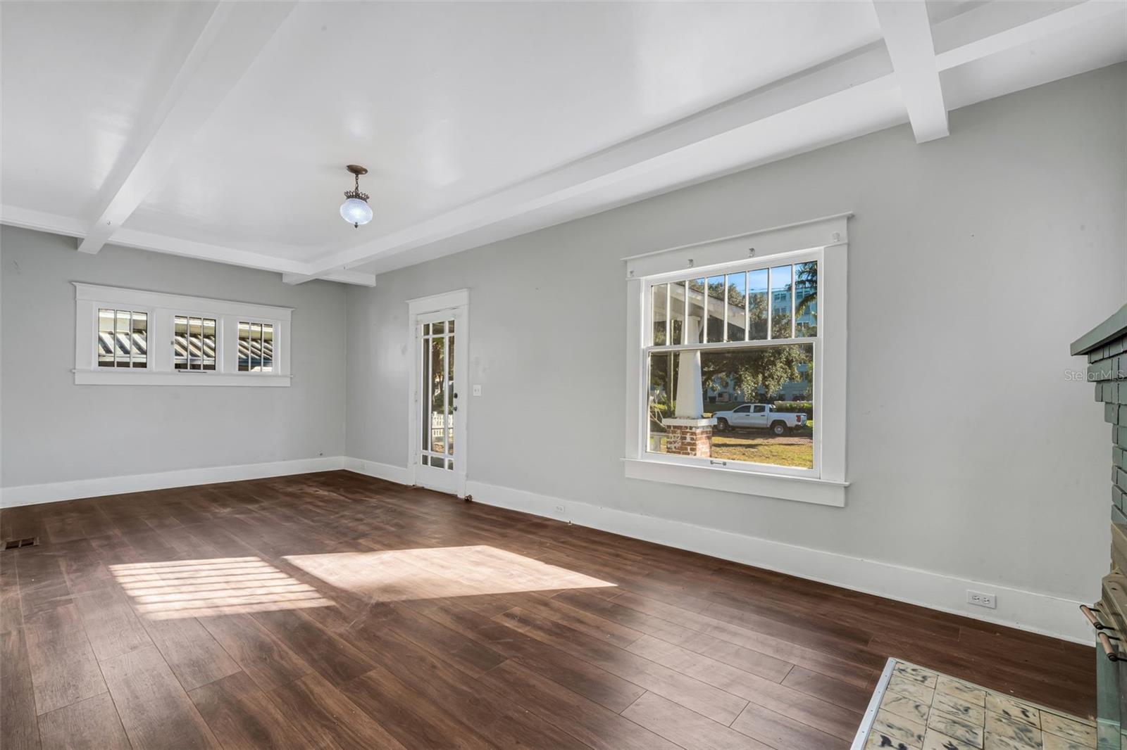 Living Room with Wood Burning Fireplace and Beautiful Ceiling Beams