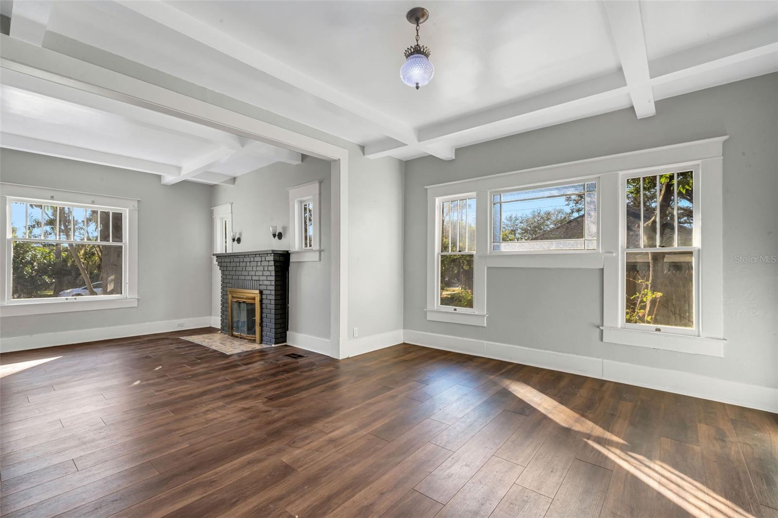 Living Room with Wood Burning Fireplace and Beautiful Ceiling Beams