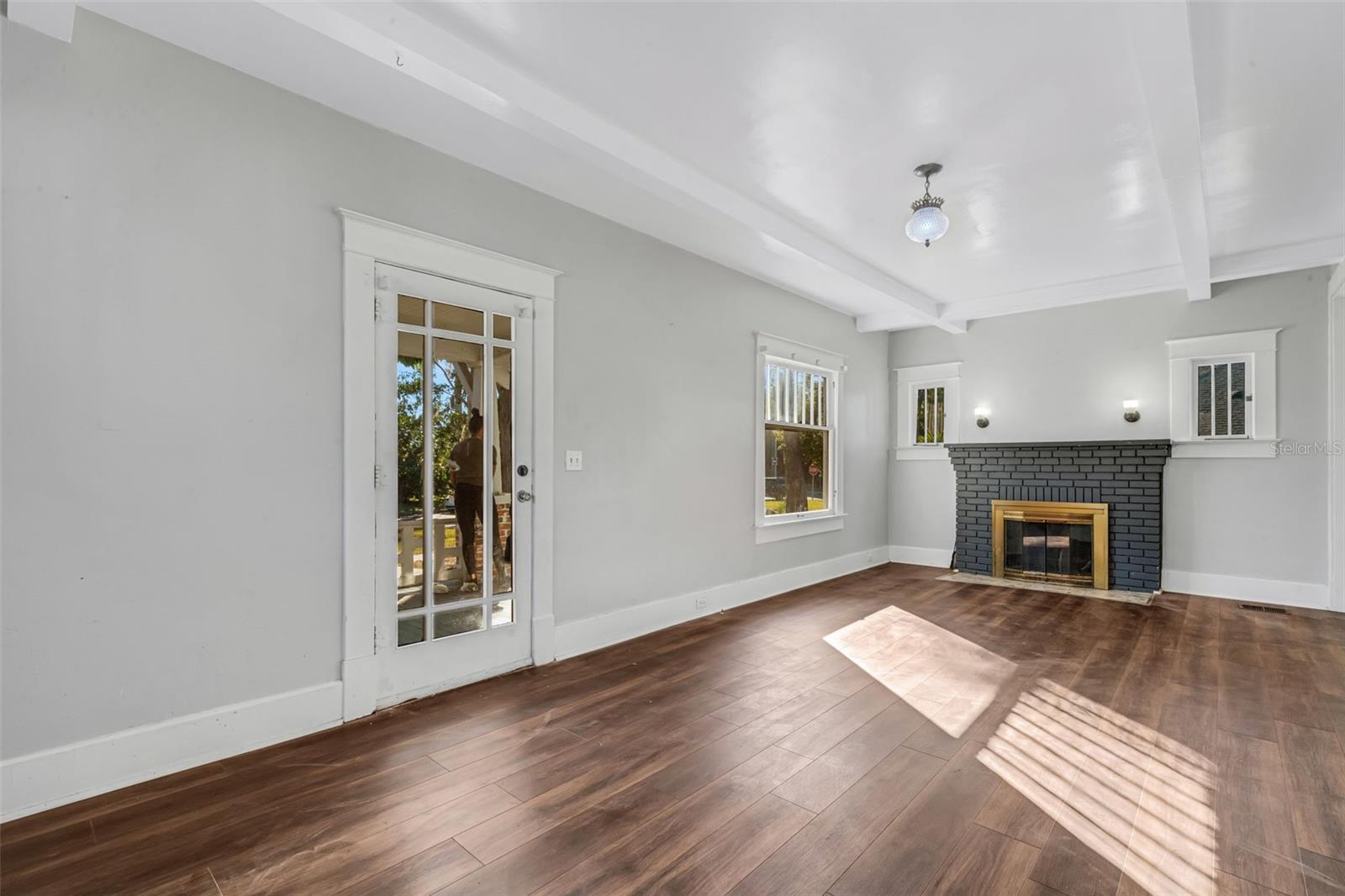 Living Room with Wood Burning Fireplace and Beautiful Ceiling Beams