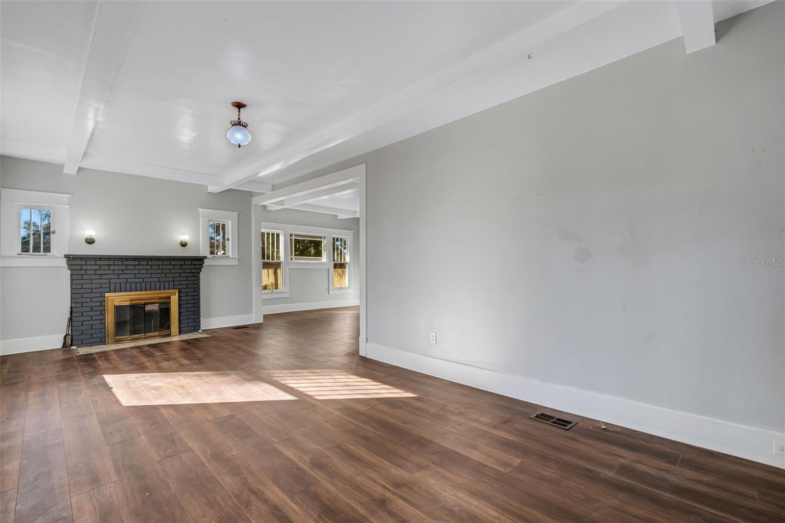 Living Room with Wood Burning Fireplace and Beautiful Ceiling Beams