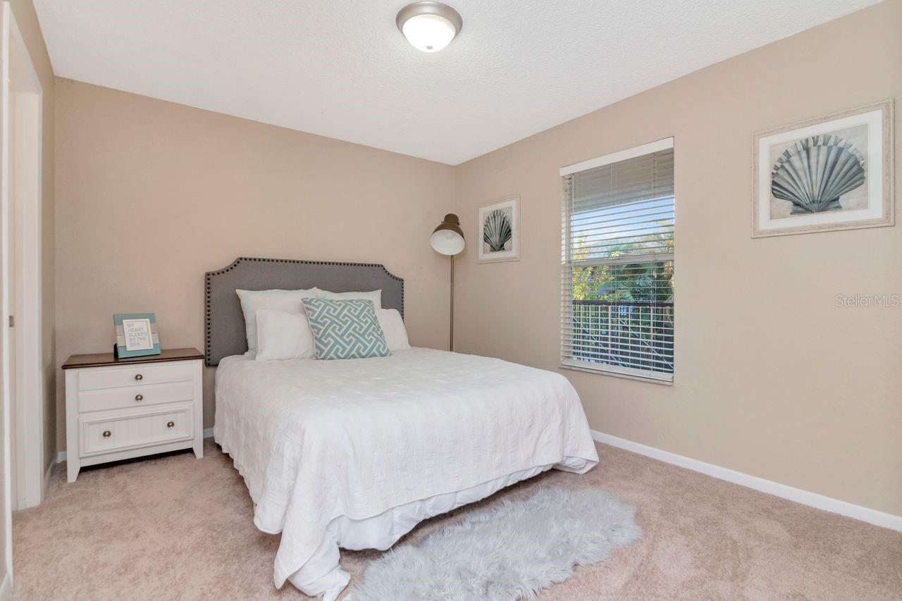 Bright primary bedroom featuring a private en-suite bath.
