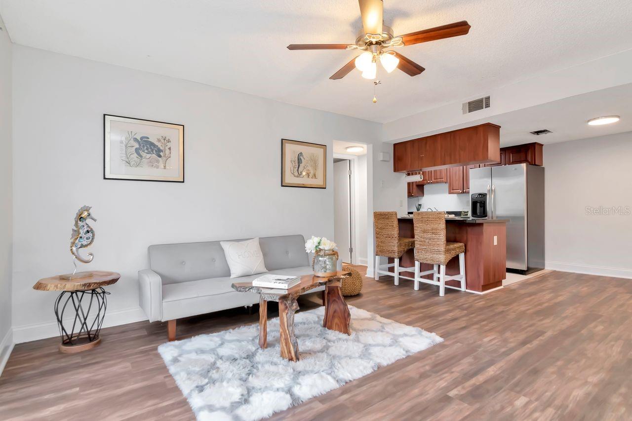 Inviting living room with new flooring and a sleek breakfast bar.