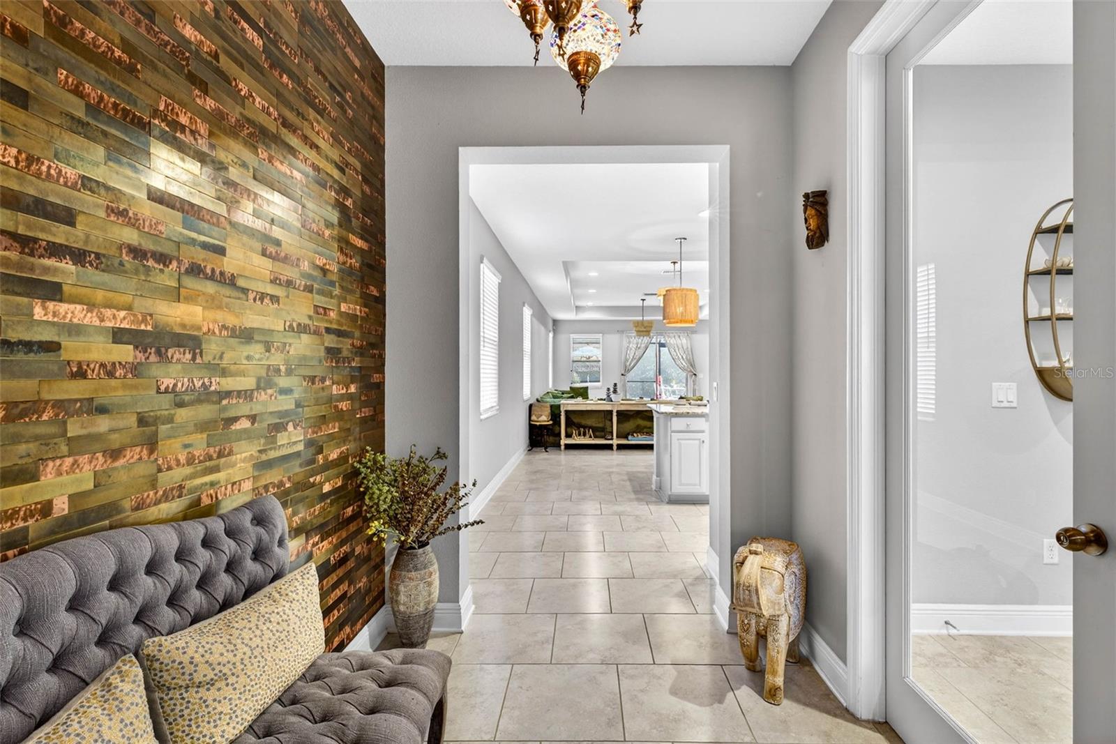 Entryway with ornate lighting fixture and open corridor.