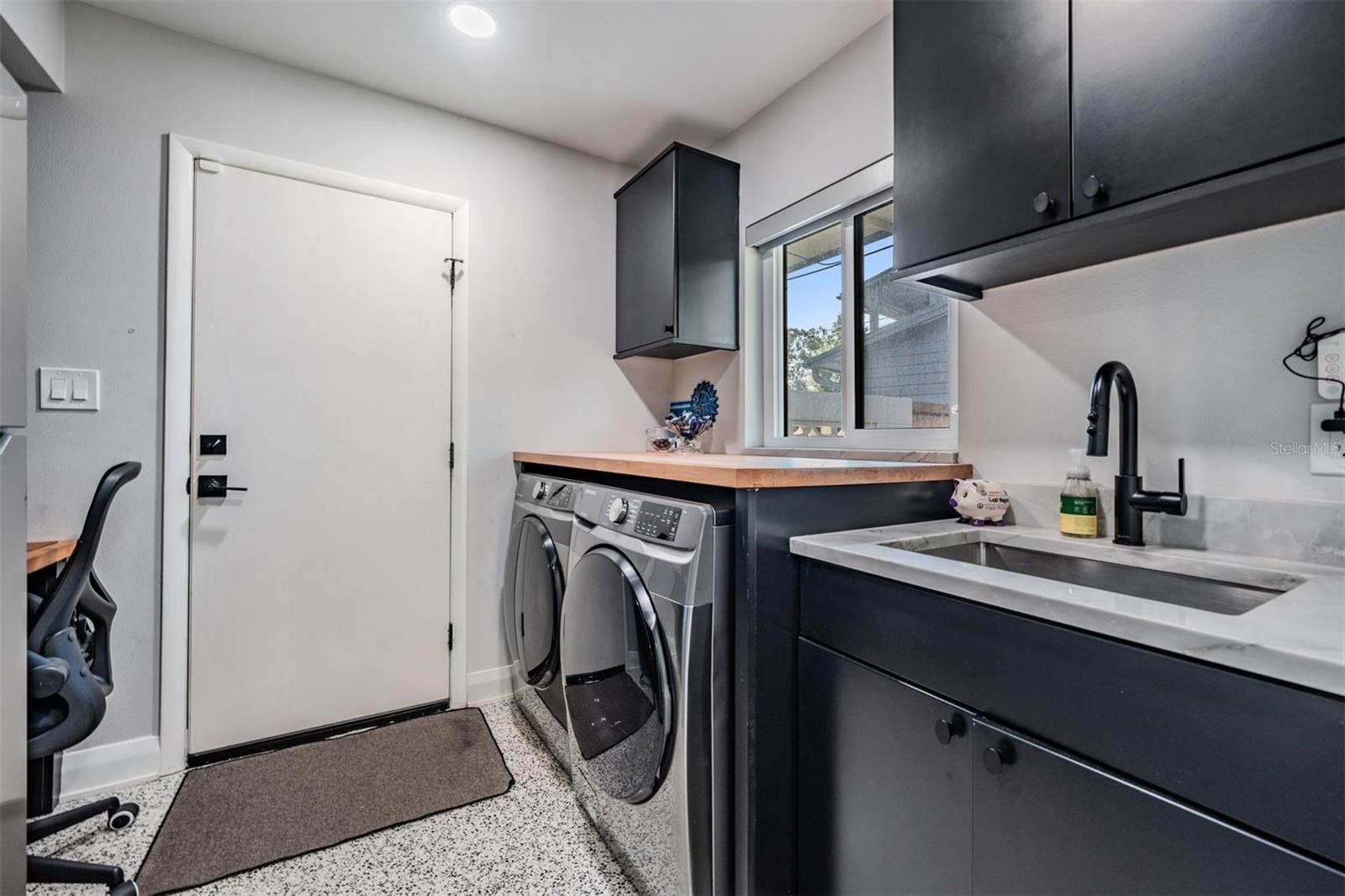 Laundry room with access to carport