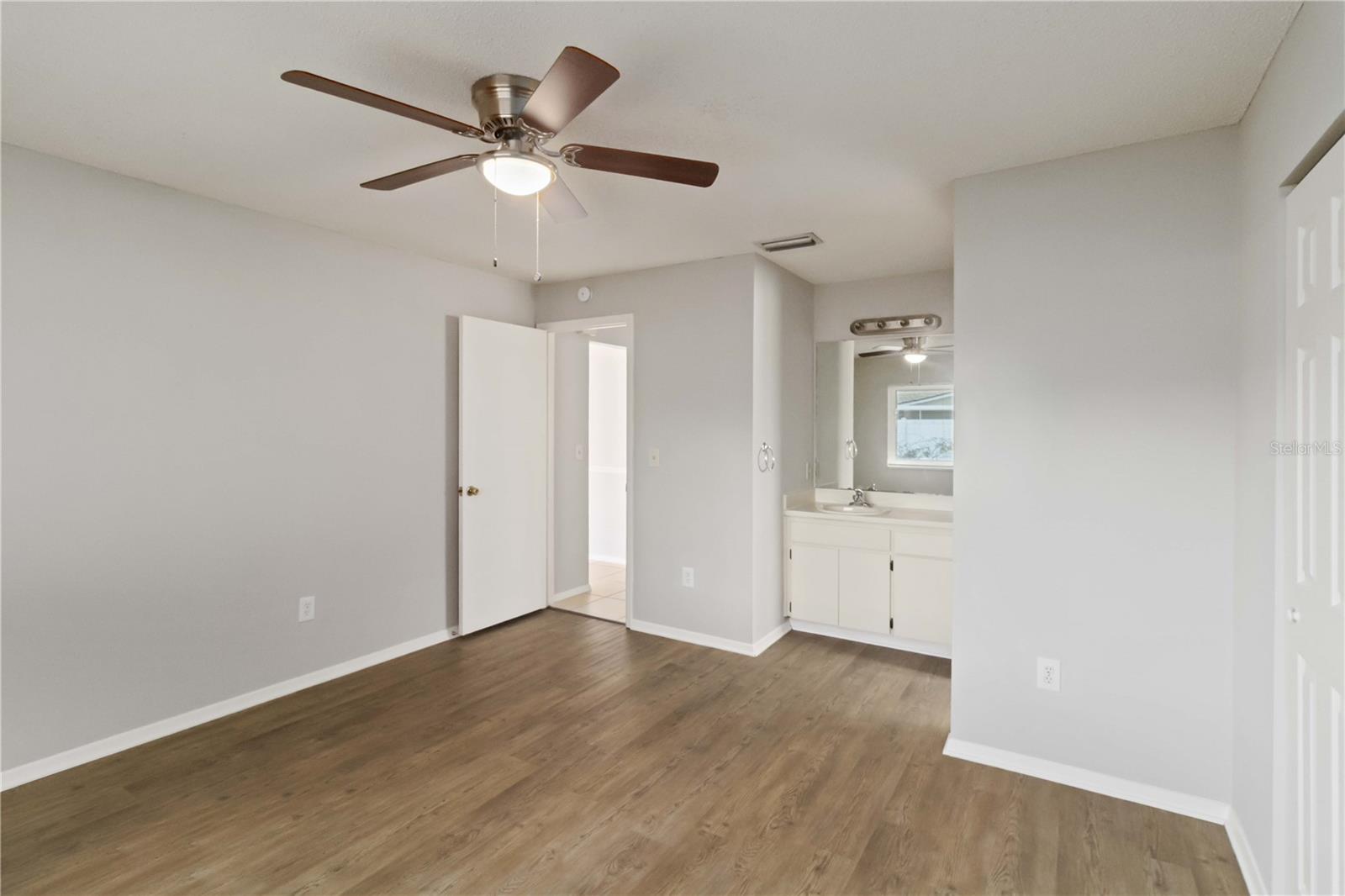 Primary bedroom with view to door and hallway.
