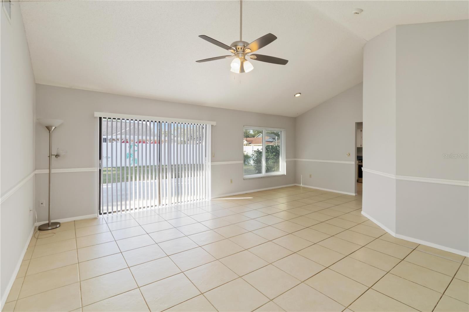 Living Room w/ sliding glass door to the backyard.
