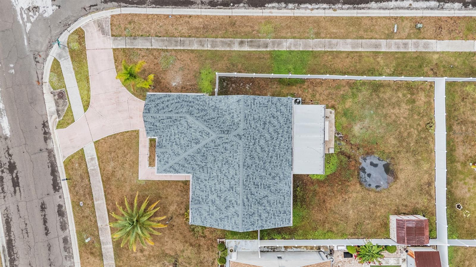 Corner lot with circular driveway & fenced yard