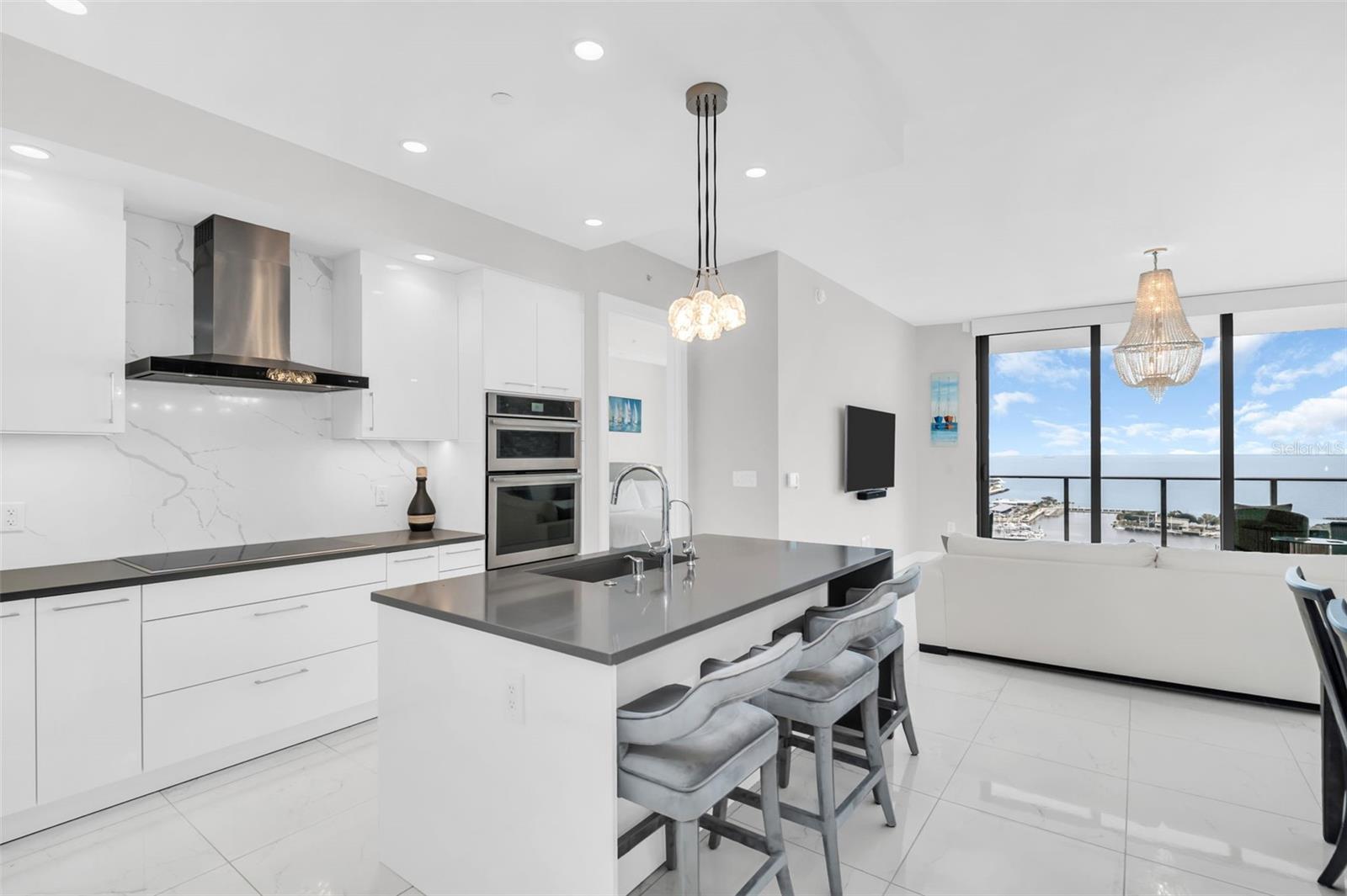 Nolte custom kitchen with quartz countertop, Grohe faucet and water dispenser on eat-in island