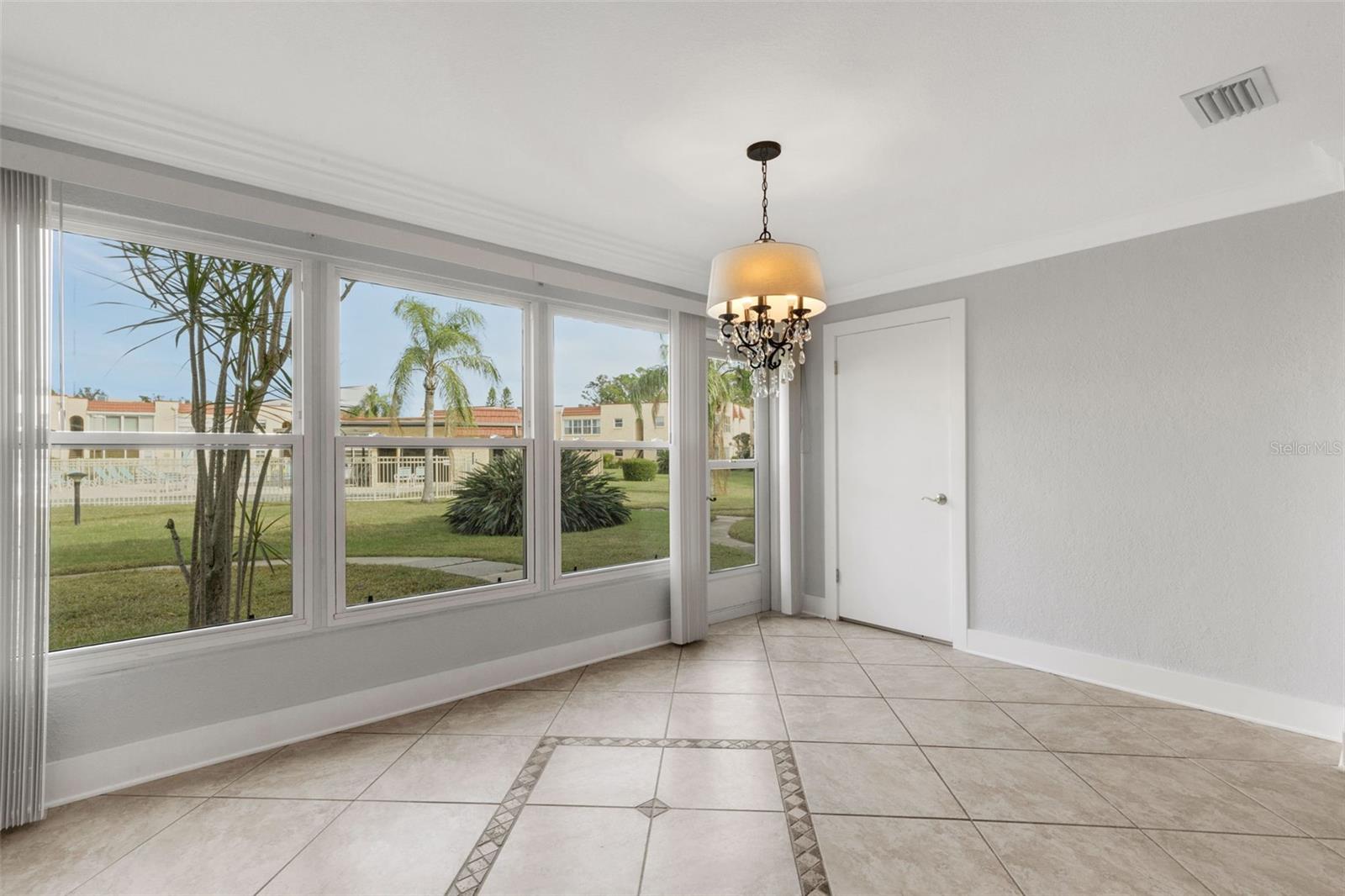 Florida Room with Interior Door to Storage and Pedestrian Door to Walkway to Pool and Clubhouse