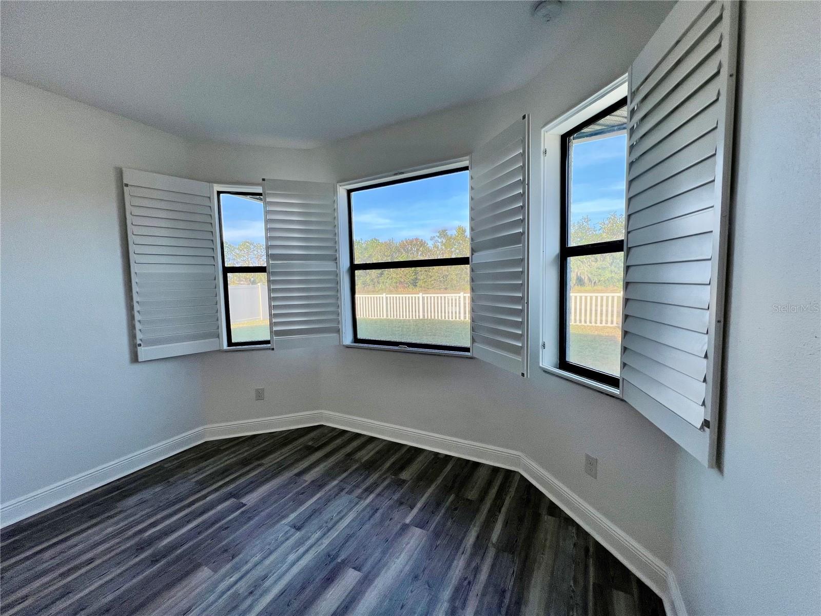 View from primary bedroom looking out into the backyard.