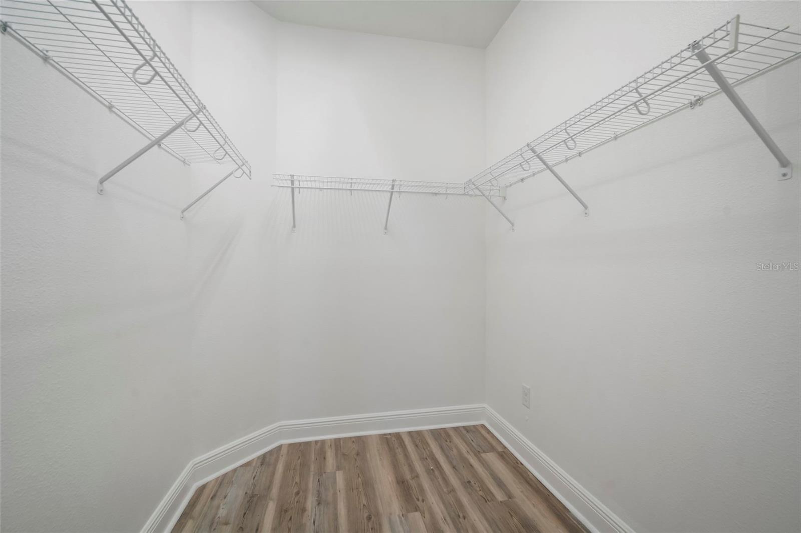 Walk-in closet in primary bedroom.