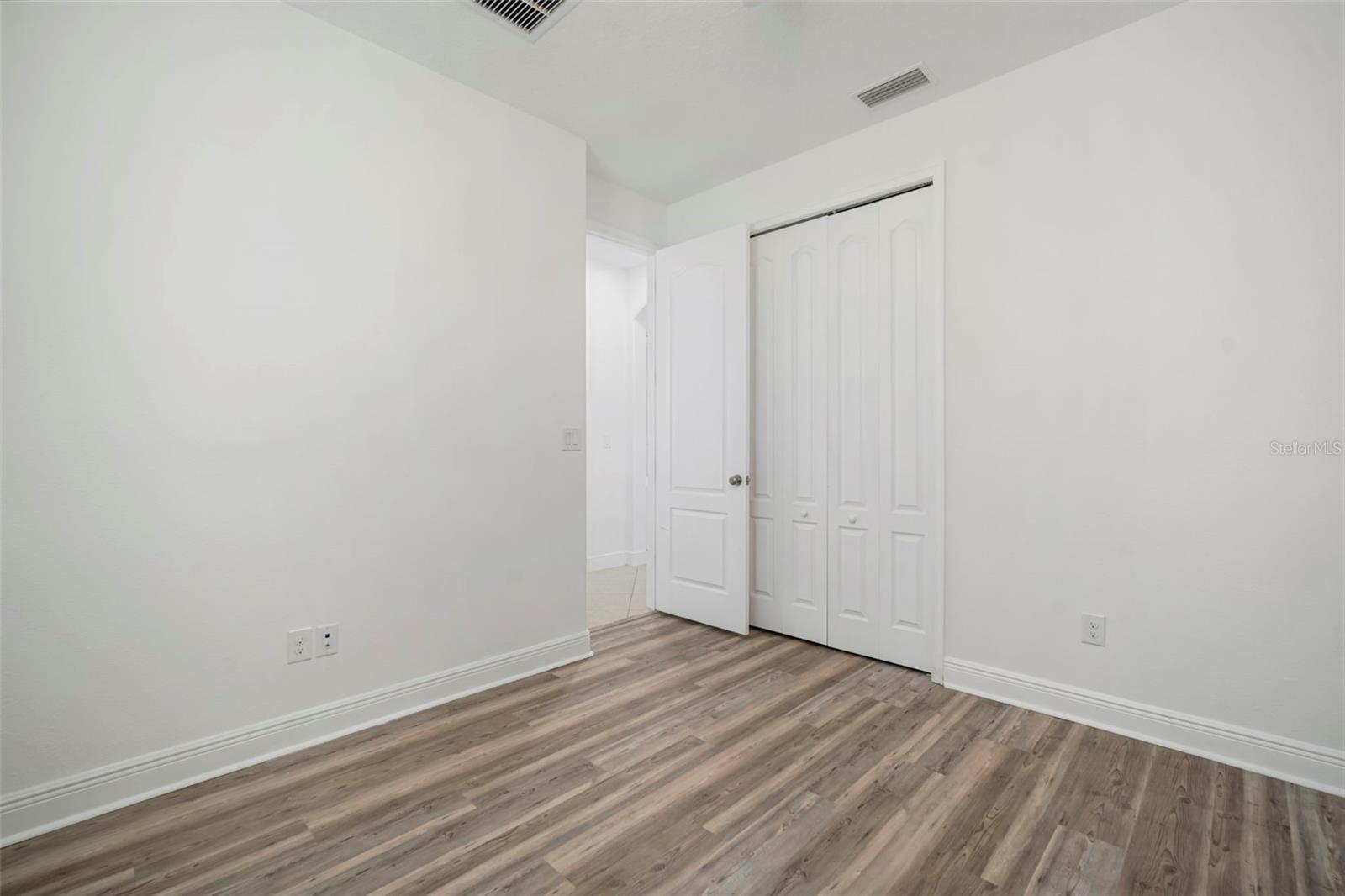Bedroom 2 closet and doorway.