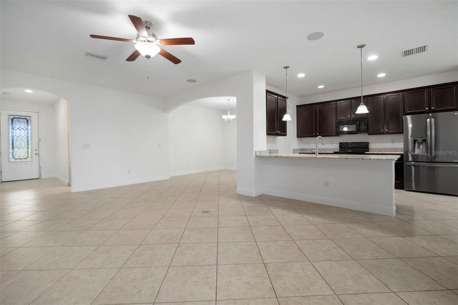 Living room looking into partial kitchen.