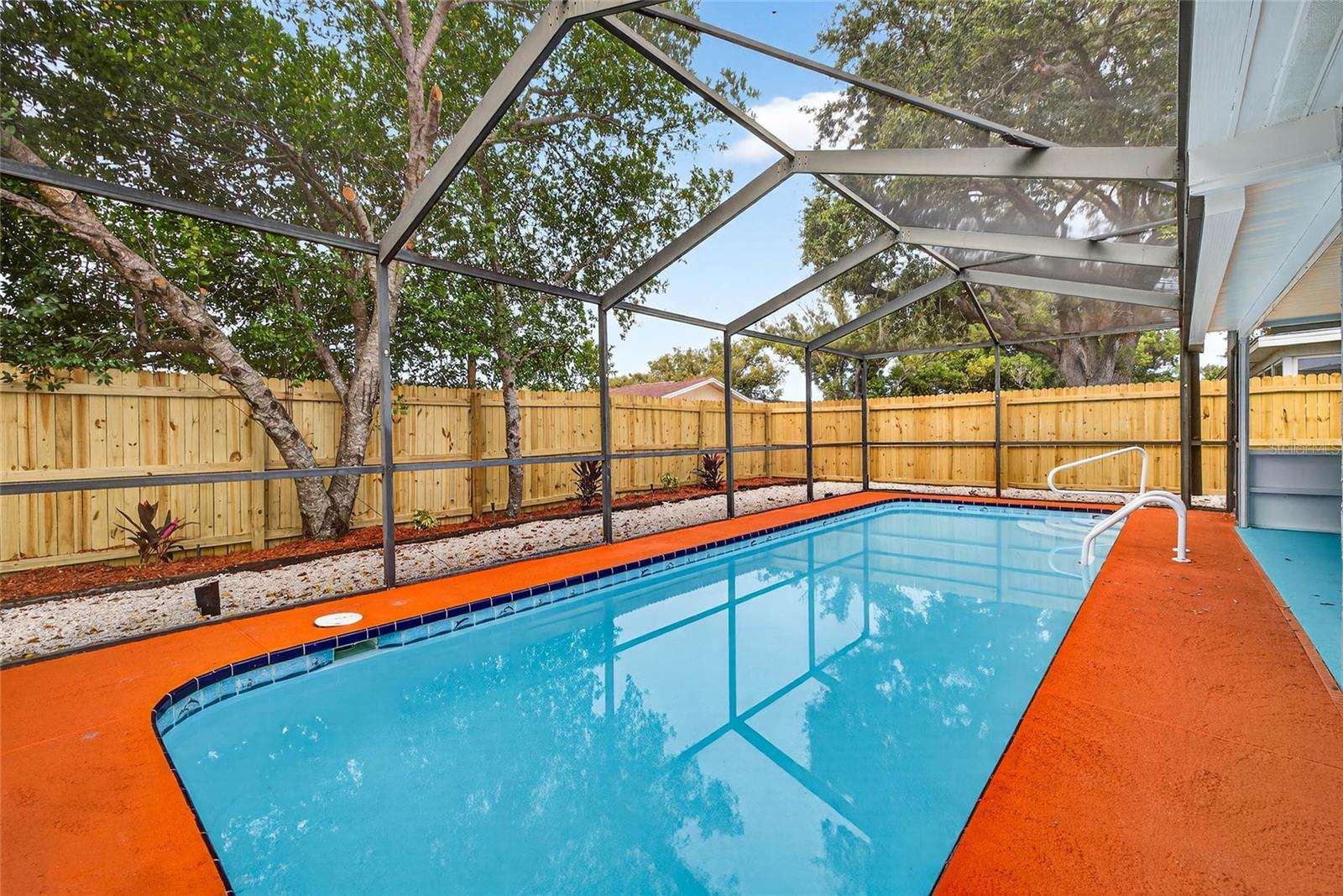 in-ground concrete pool and brand-new privacy fence
