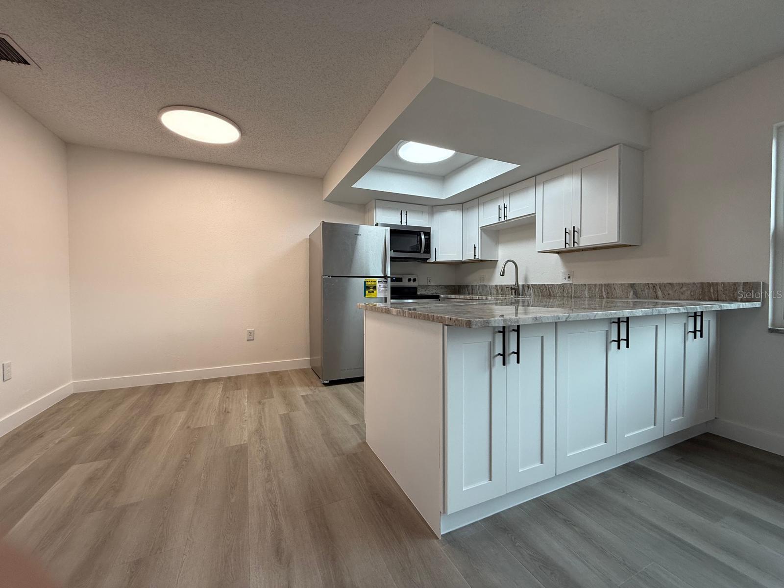 Brand new beautifully updated stone counter tops with shaker style soft close cabinets and drawers.