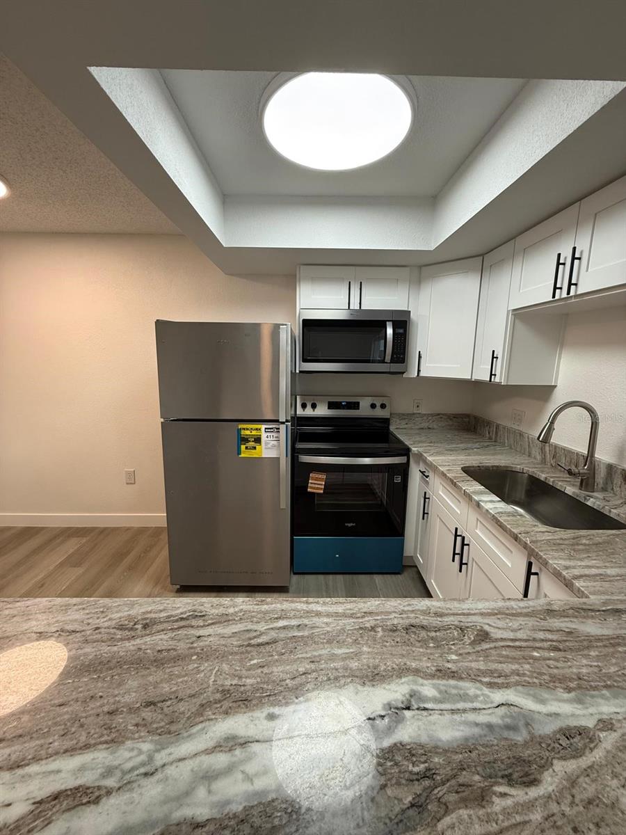 A suite of brand new Whirlpool Appliances, freezer has ice maker.