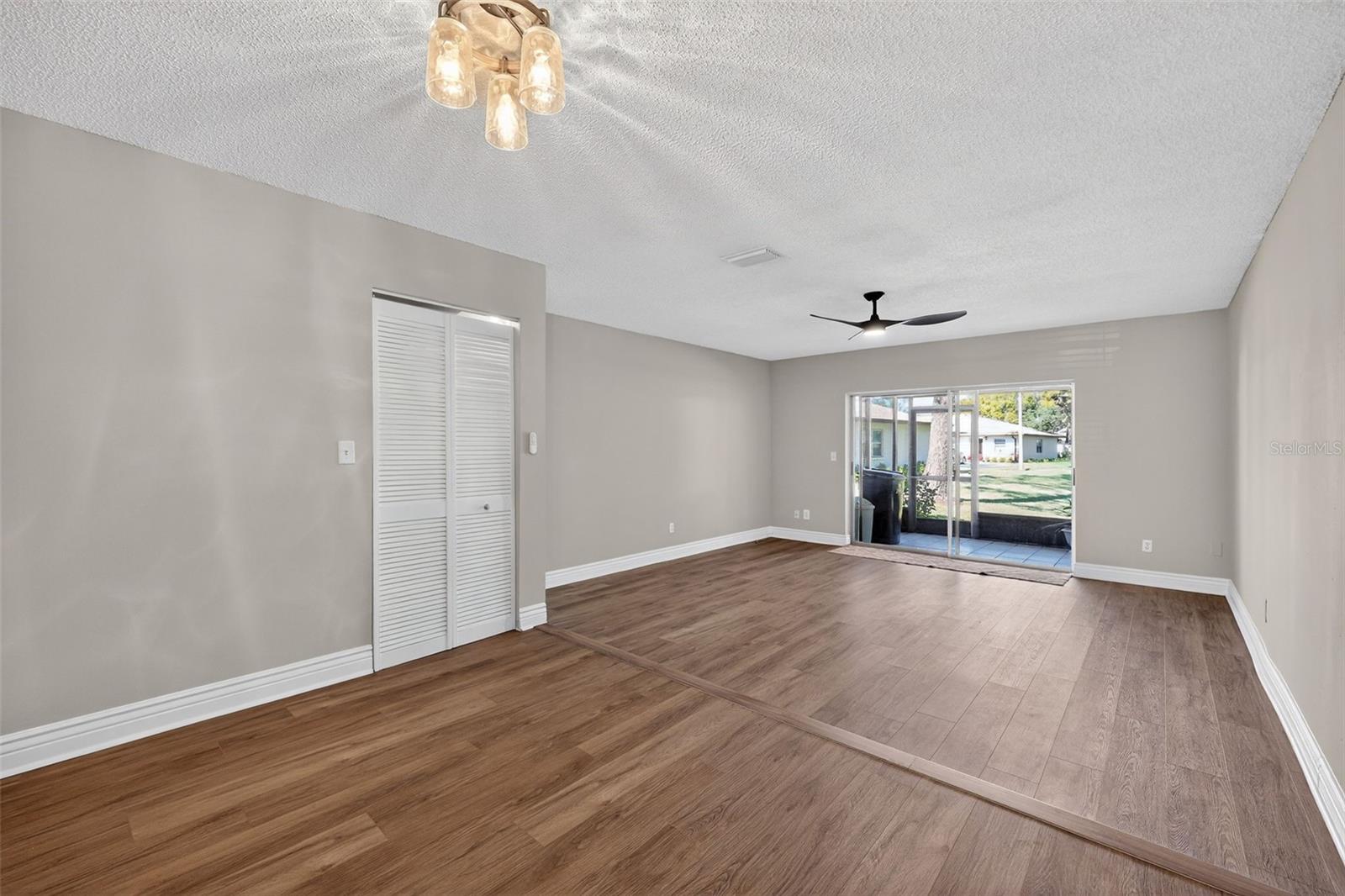 Living Room toward Covered Patio.  Bi-Fold Laundry Rm