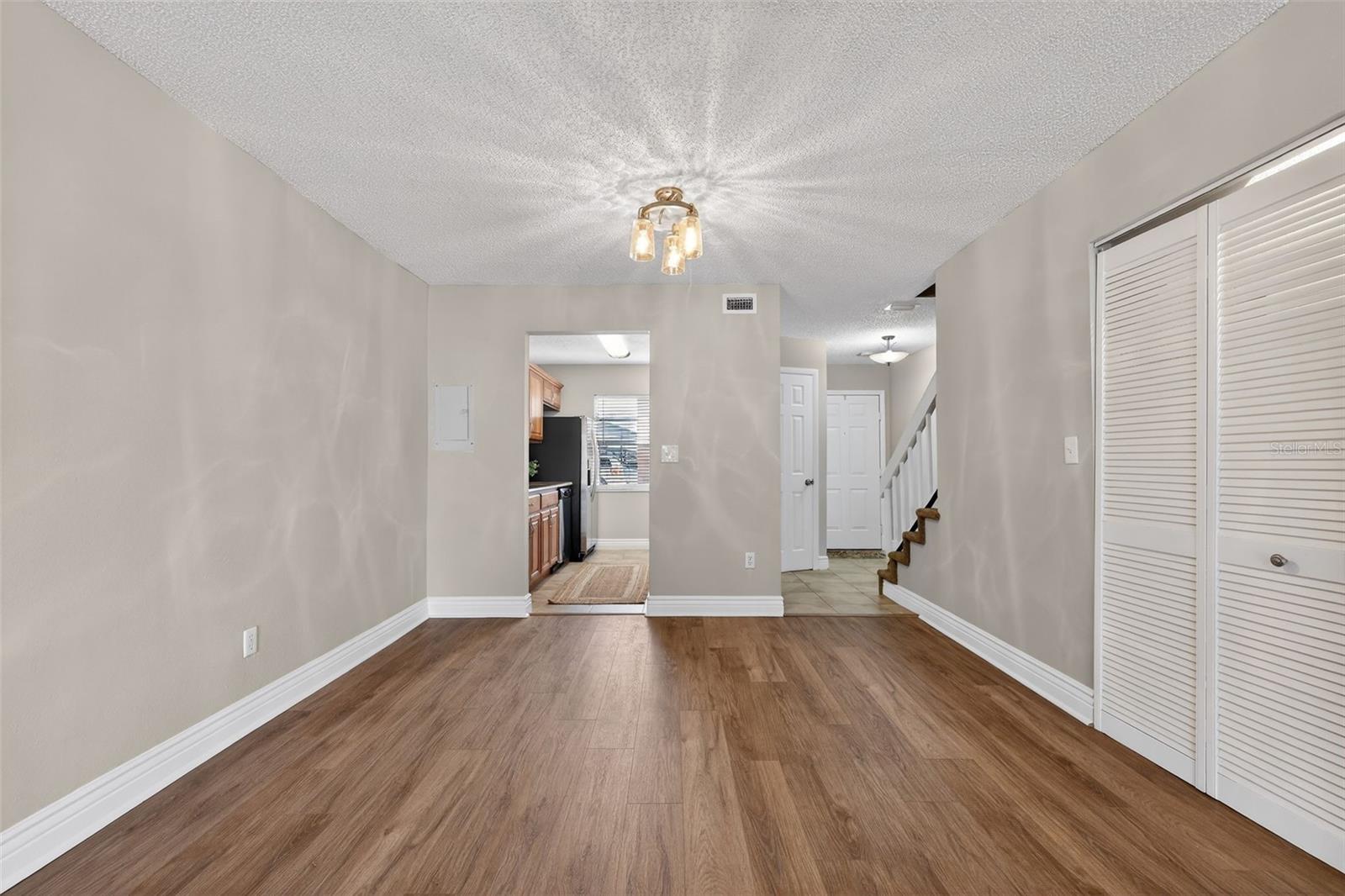 Great Room looking Back at Kitchen & Front Entrance Laundry to right