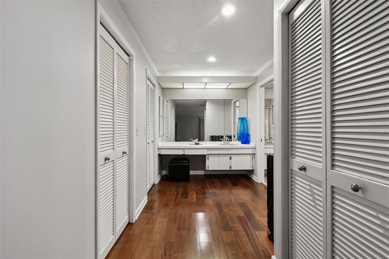 Primary Bathroom Entry with 2 Walk In Closets on the Left and Linen Closet on the Right