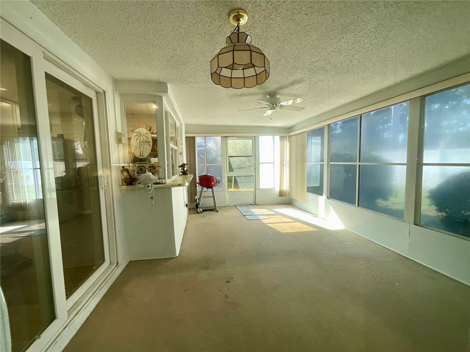 View from Primary bedroom through slider to Florida room