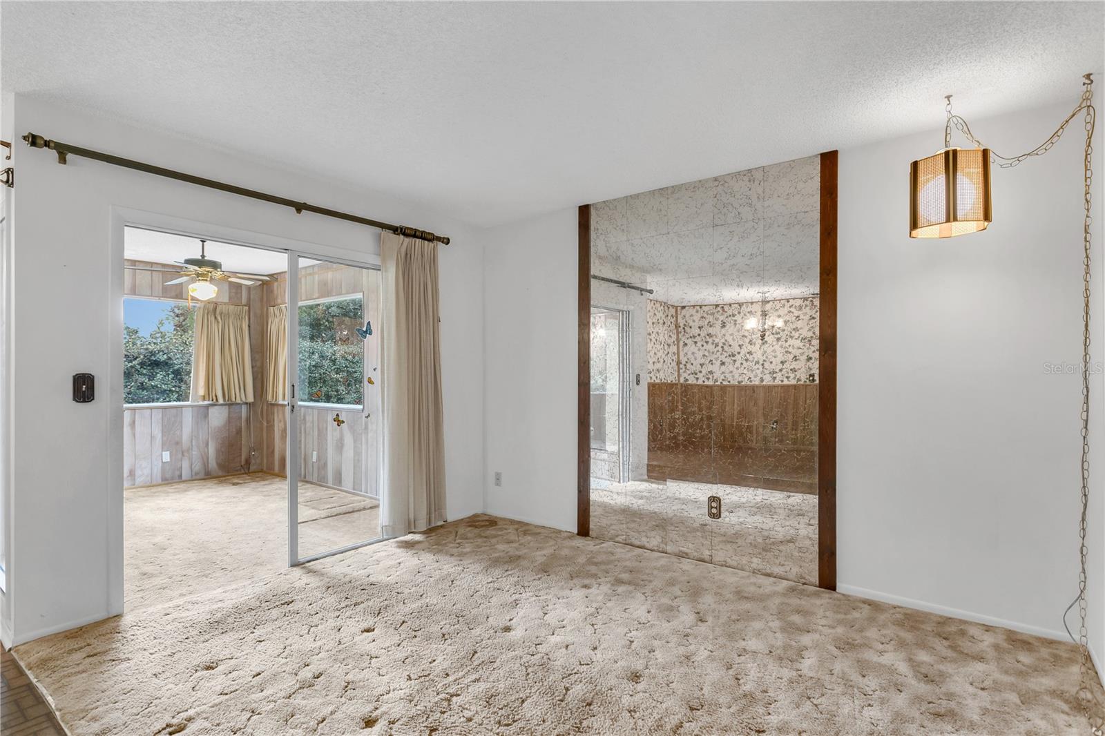 Living room with separate office with sliding glass doors