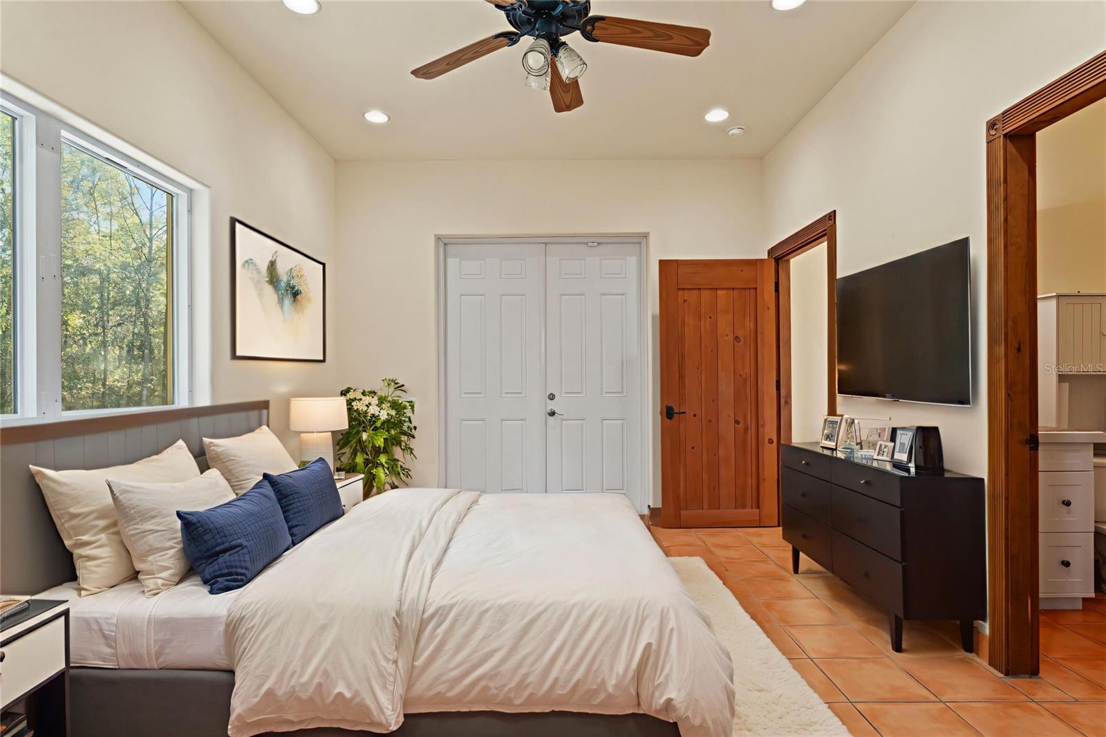 Another perspective reveals a spacious closet, an oversized  layout, and access to an en suite area, making this room a retreat.