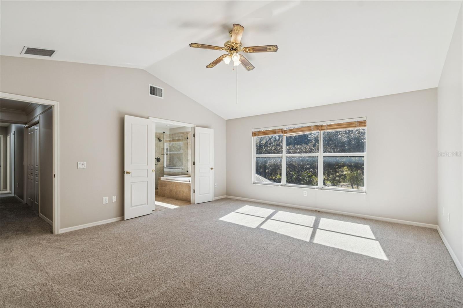 Primary suite with stunning view of woods and water