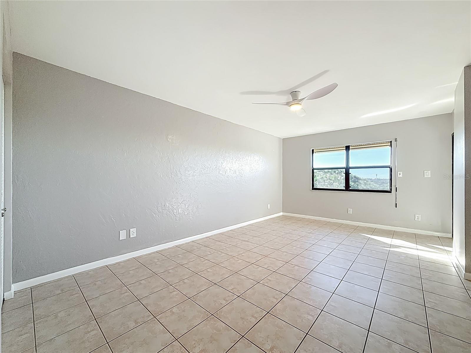 Large primary bedroom with tile flooring