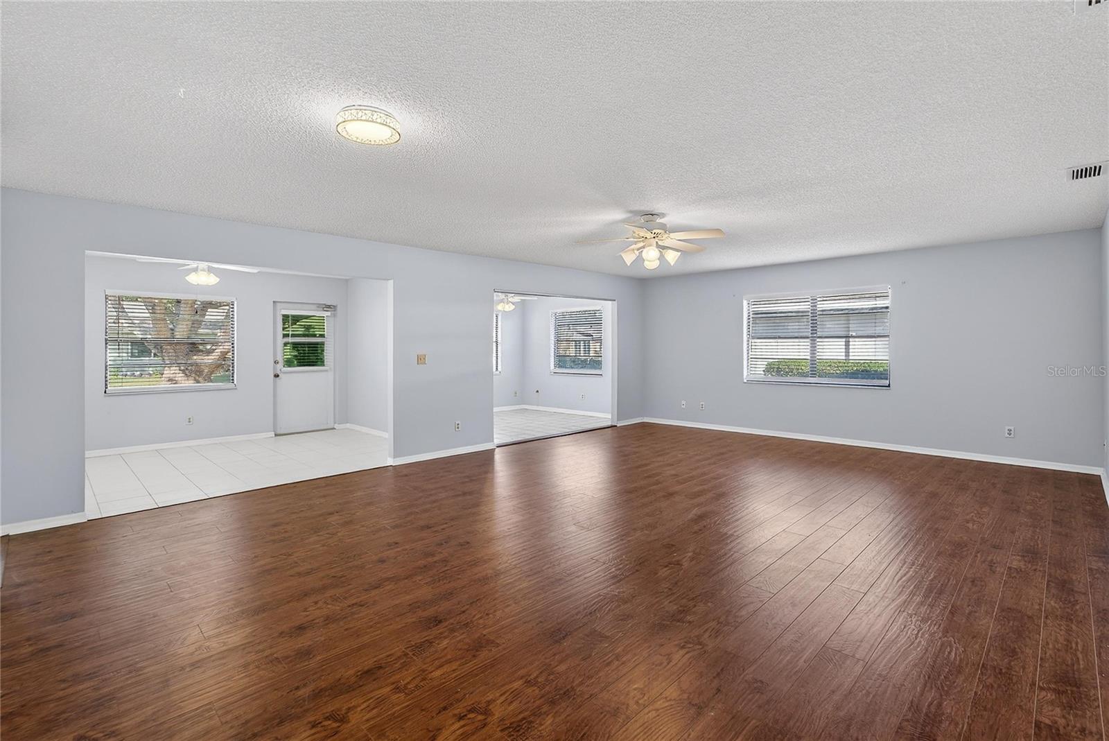 Formal living/dining room with view of flex room and possible 3rd BR or office