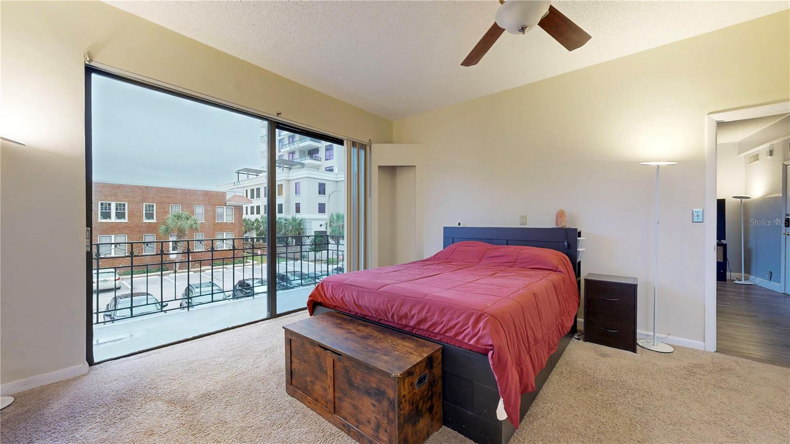 Spacious primary bedroom with a balcony