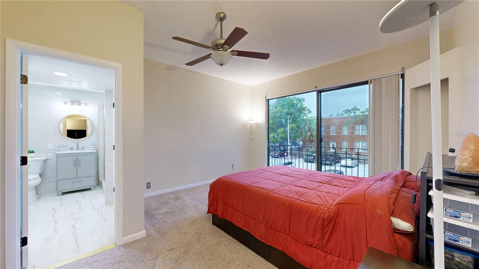 Spacious primary bedroom with a balcony