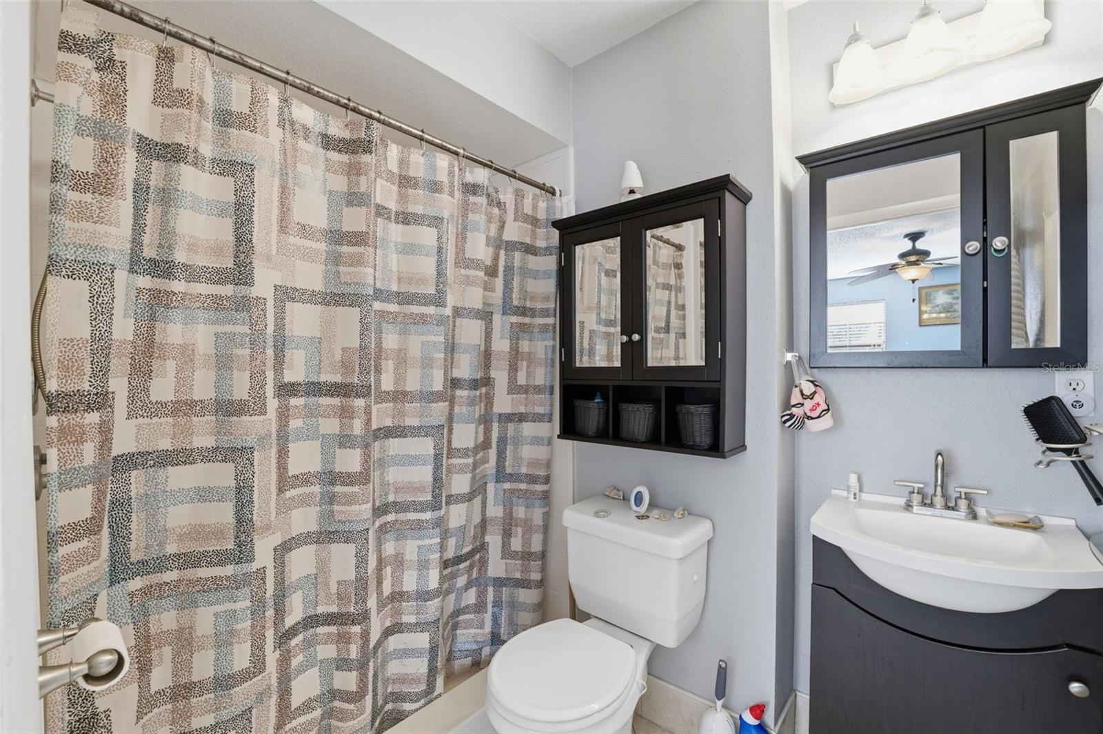 Full bathroom with updated vanity and ample storage.