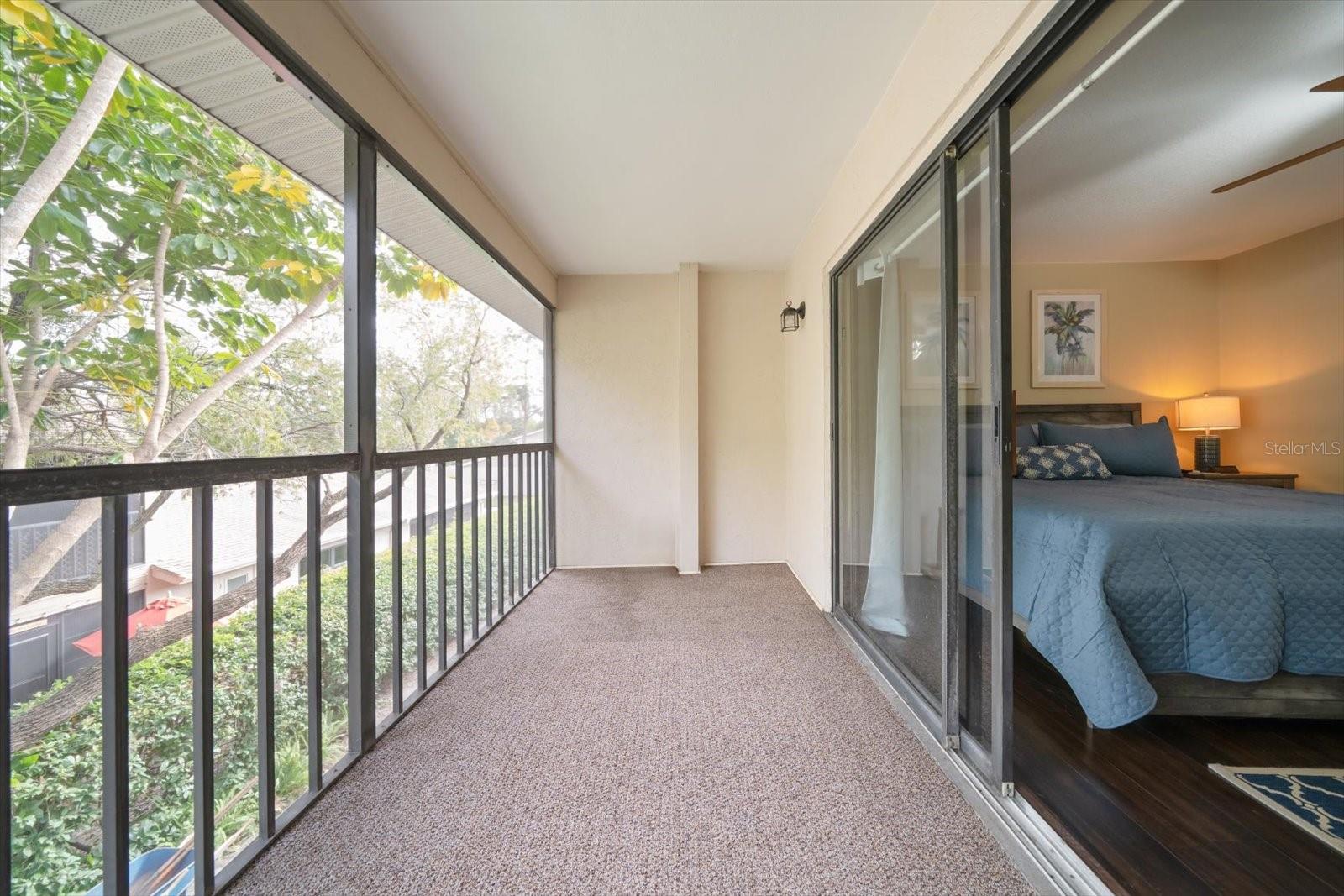 Private screened-in balcony of off the primary bedroom.
