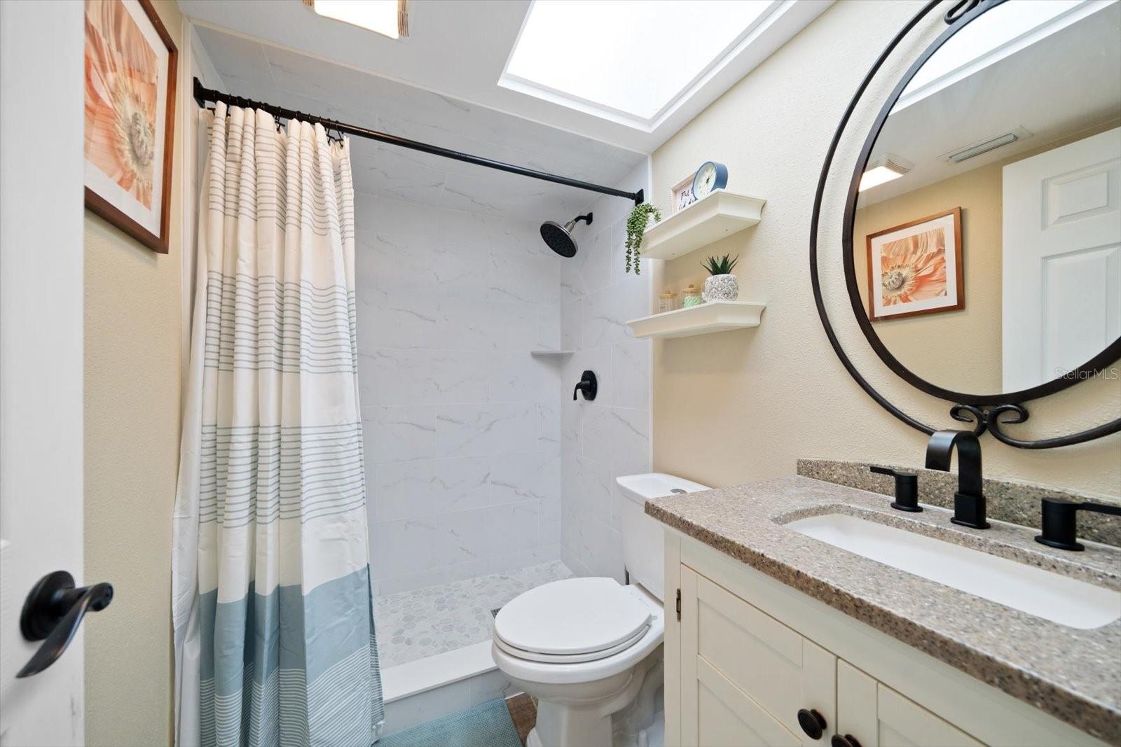 The shared full bathroom upstairs has been recently renovated with new tile finishes!