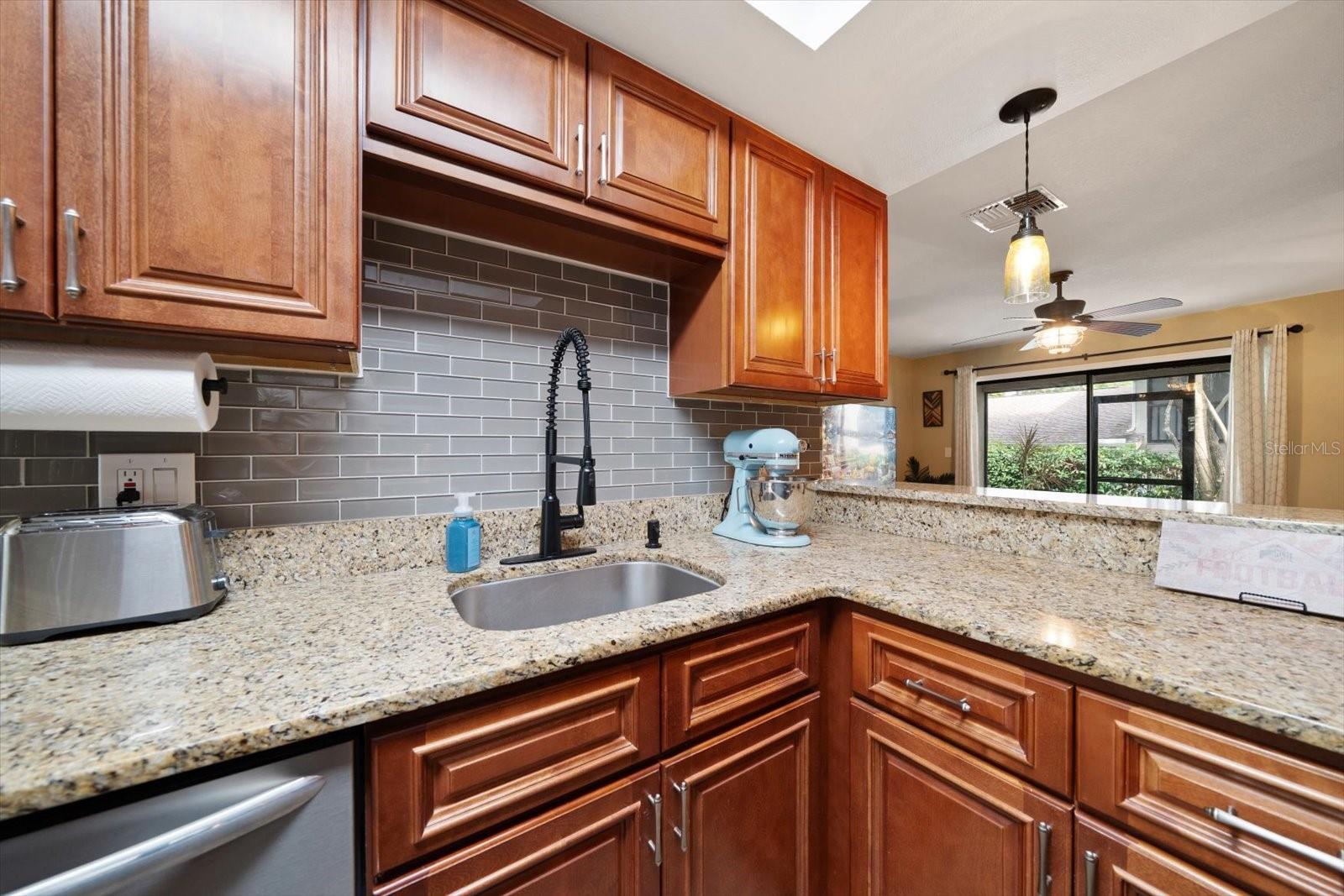 Featuring ample stone counter space, this is the perfect prep station for making any meal.