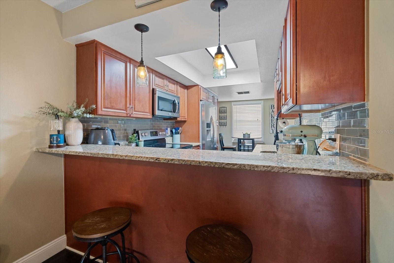 An ample breakfast counter provides added seating space for guests.