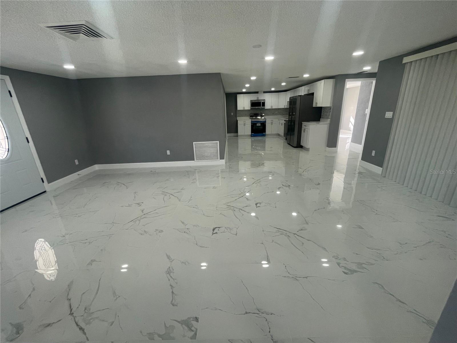 VIEW FORM BEDROOMS TO LIVING/DINNING AREA KITCHEN AT THE END