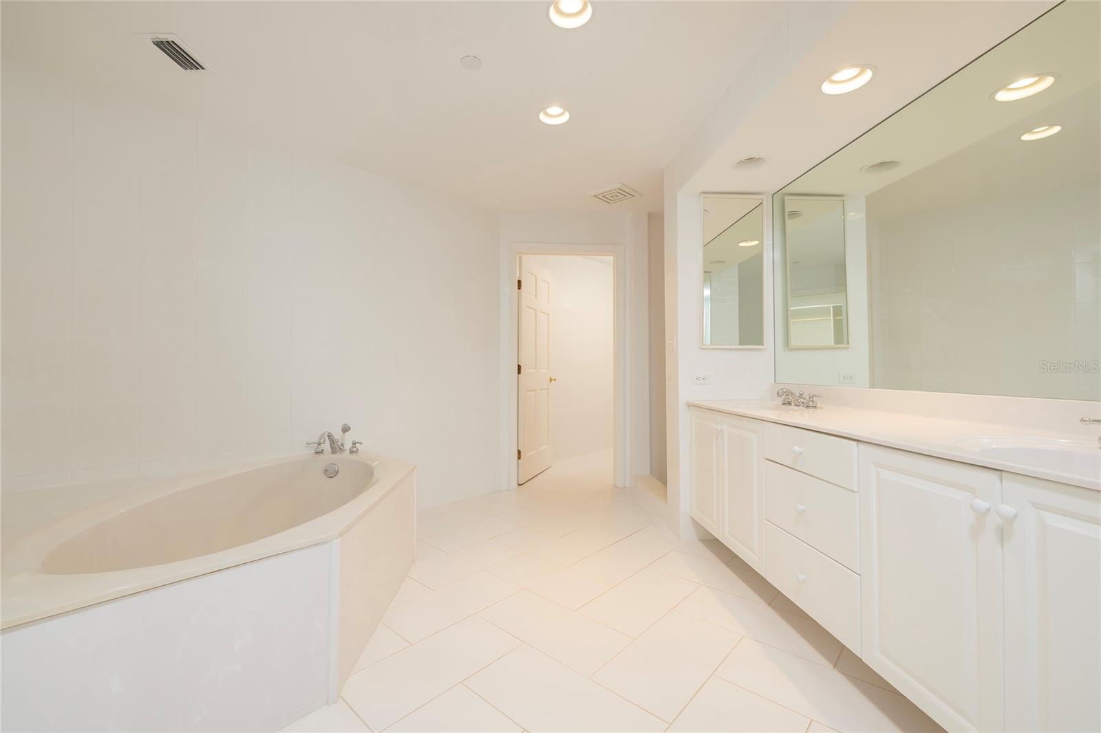Master Bathroom with soaking tub, separate shower, dual vanities and separate water closet
