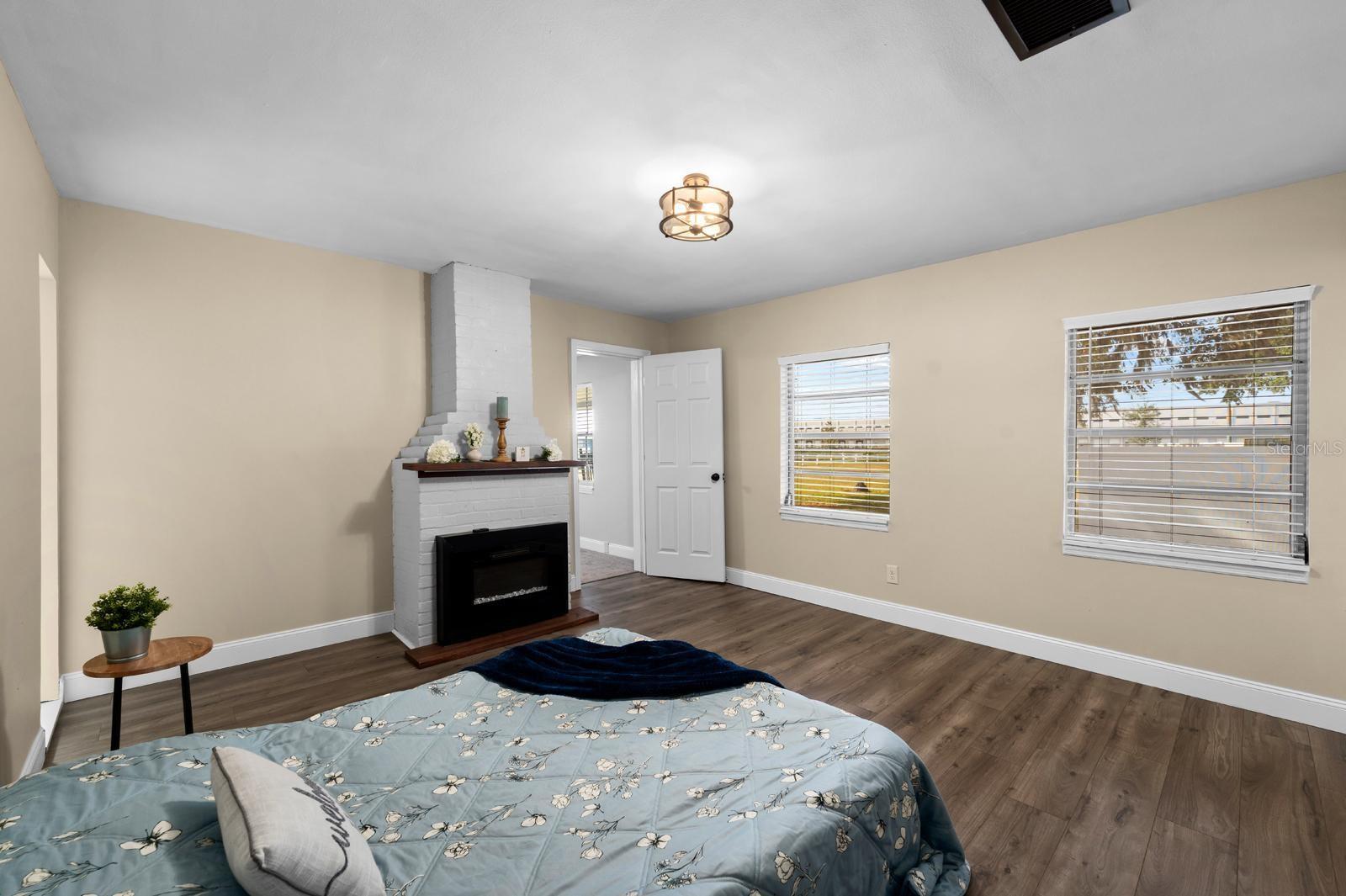 The downstairs bedroom has a brick electric fireplace, fresh paint, new lighting, new window blinds, updated 5-1/2' baseboards, and a NEW BARN DOOR is being installed at the closet entry.  The staging bed is a QUEEN SIZE.