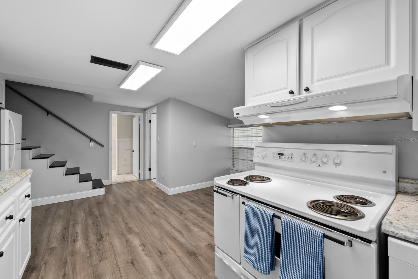The updated kitchen features a beautiful farm sink, newer cabinets and countertops, newer appliances, the extra large range features a second oven, a range hood, new lighting, over-the-sink lighting, an updated faucet, and backsplash.