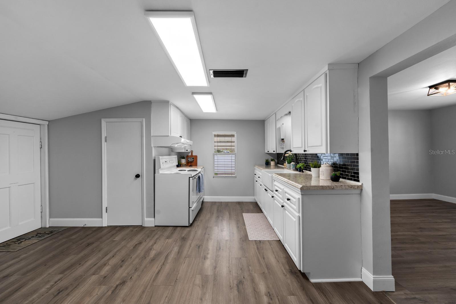 The door to the left is a walk-in pantry, and there's space for a table near the back door.