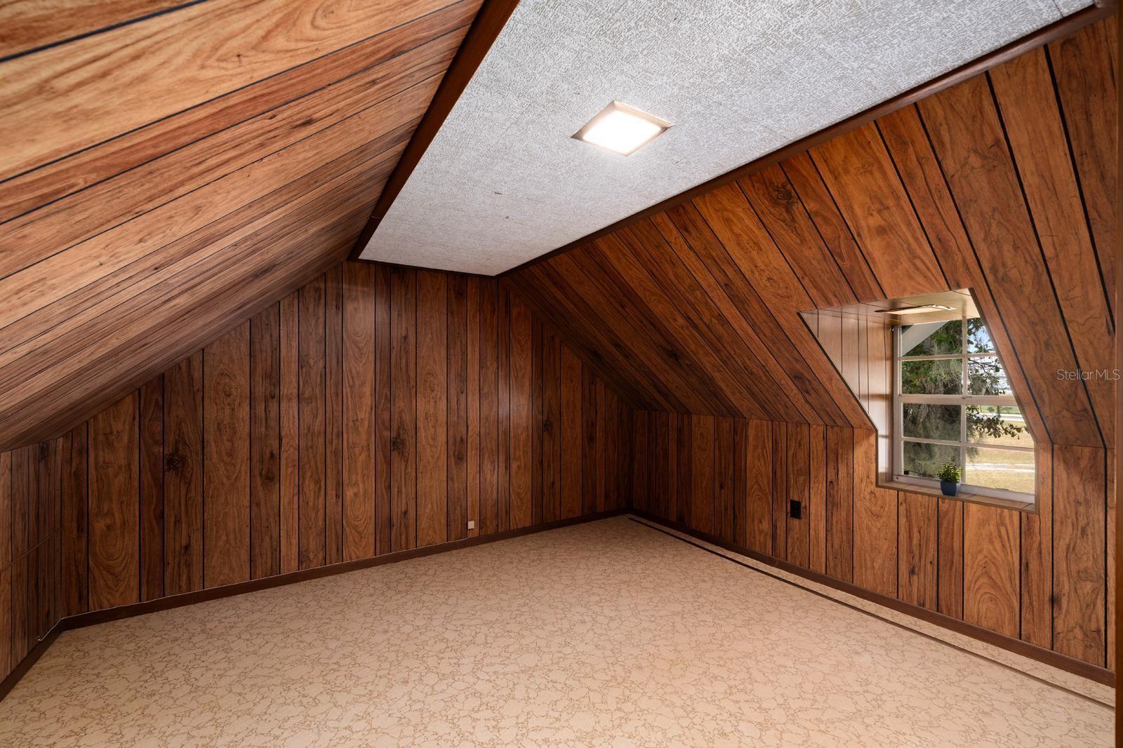 The second bedroom has waterproof, linoleum flooring and also features beautiful, 70's style paneling.