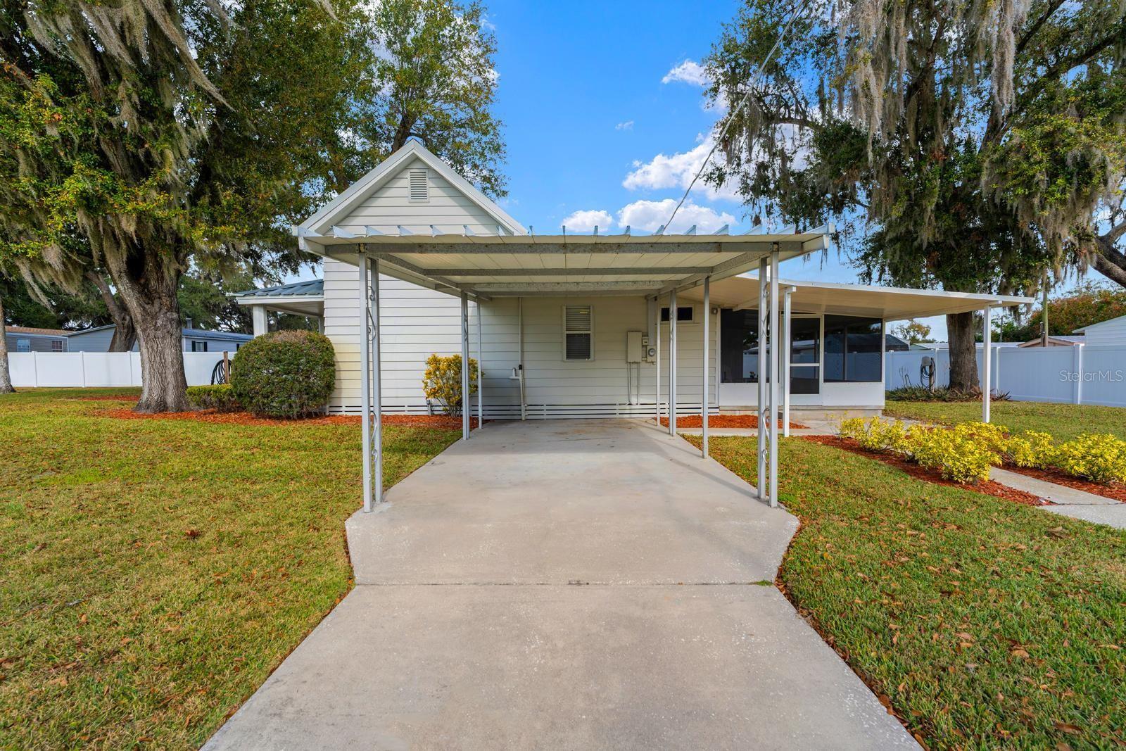 A long carport extends off the south side of the home.