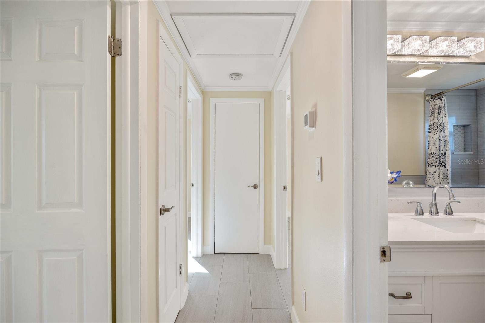 Hallway leading to 3 bedrooms and 1 bathroom